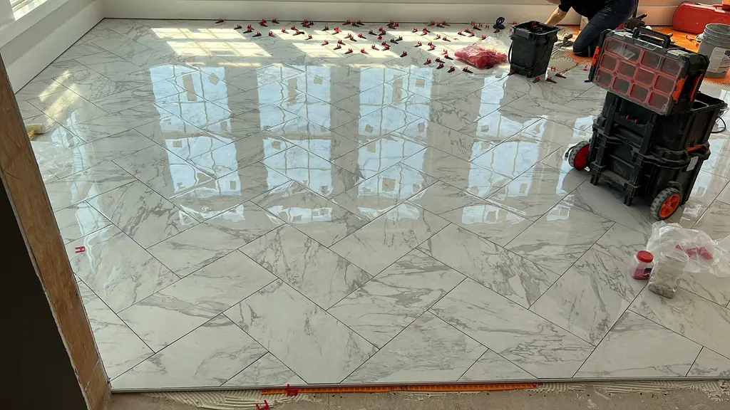 Marble-look floor tile freshly installed on the diagonal